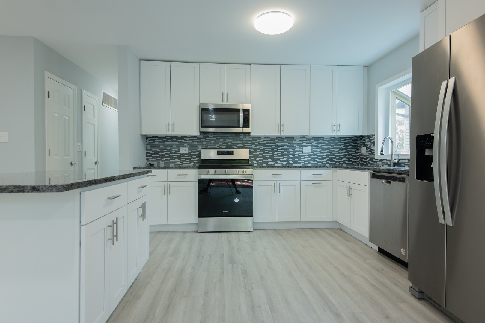 44 Redwood Trail Wheeling, IL 60090 - Photo 8 of 23 a kitchen with stainless steel appliances granite countertop a stove top oven a sink and white cabinets