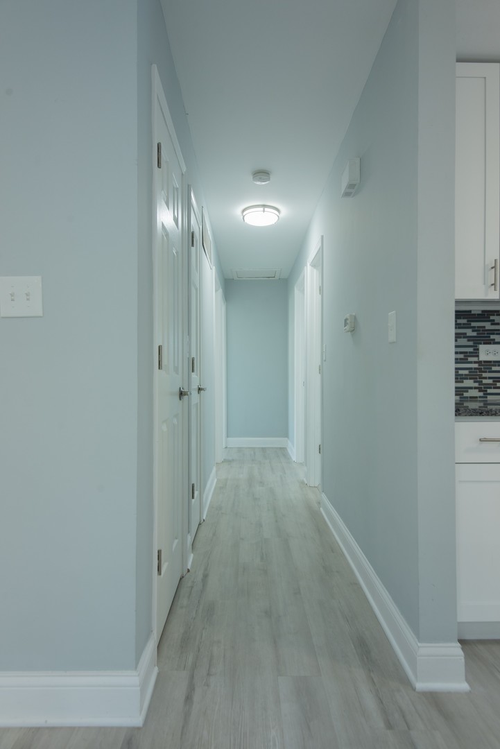 44 Redwood Trail Wheeling, IL 60090 - Photo 9 of 23 a view of a hallway with wooden floor