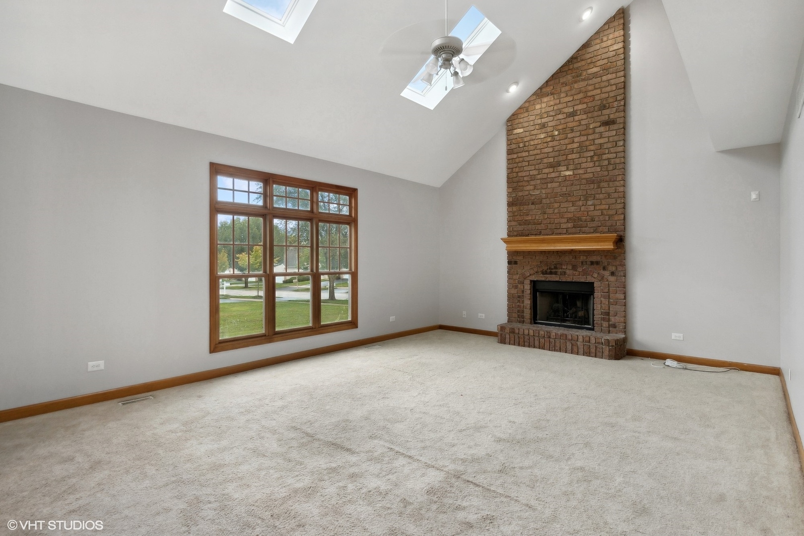 2908 Beth Lane Naperville, IL 60564 - Photo 9 of 22 an empty room with windows and fireplace