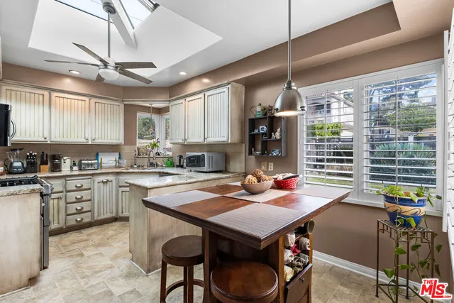 a kitchen with a sink appliances and cabinets