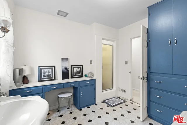 a bedroom with a bed and a dresser in it