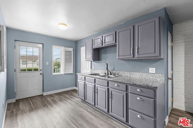 a kitchen with stainless steel appliances granite countertop a sink stove and cabinets