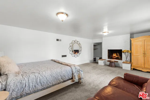 a bedroom with a large bed and a couch