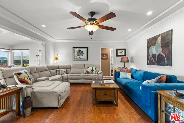 a living room with furniture and wooden floor