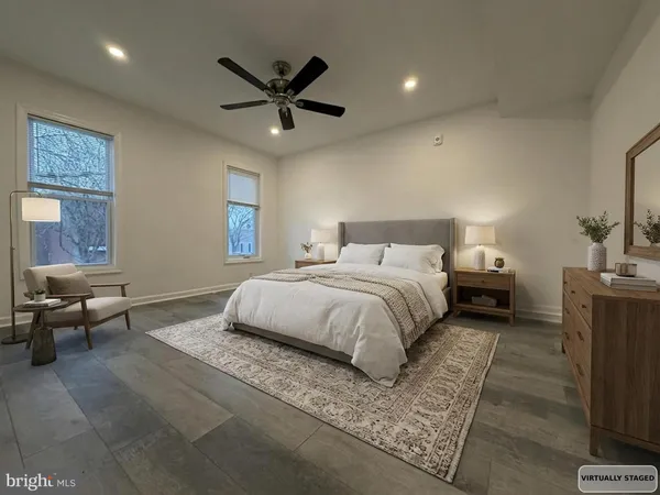 a bedroom with a bed a couch and a window