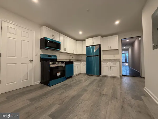 a kitchen with stainless steel appliances a refrigerator and a stove top oven