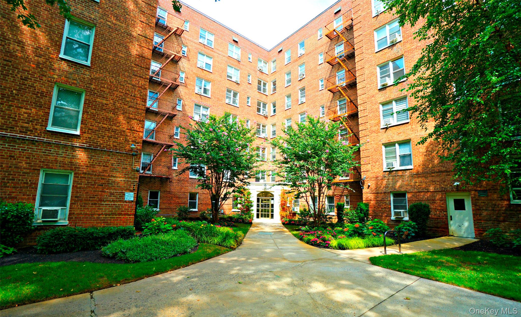 7281 113th Street, Unit 2B Queens, NY 11375 - Photo 18 of 18 a view of a brick building next to a yard