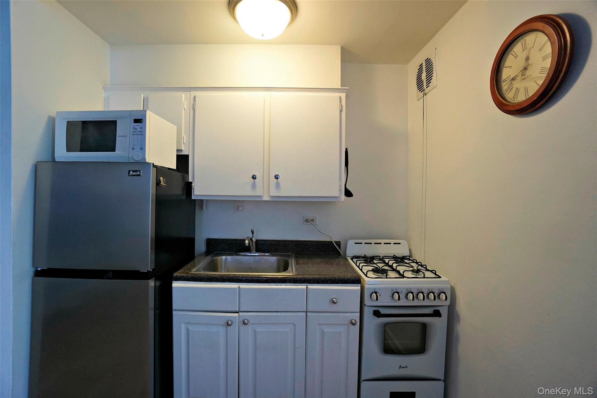 7281 113th Street, Unit 2B Queens, NY 11375 - Photo 2 of 18 a kitchen with a refrigerator and a stove