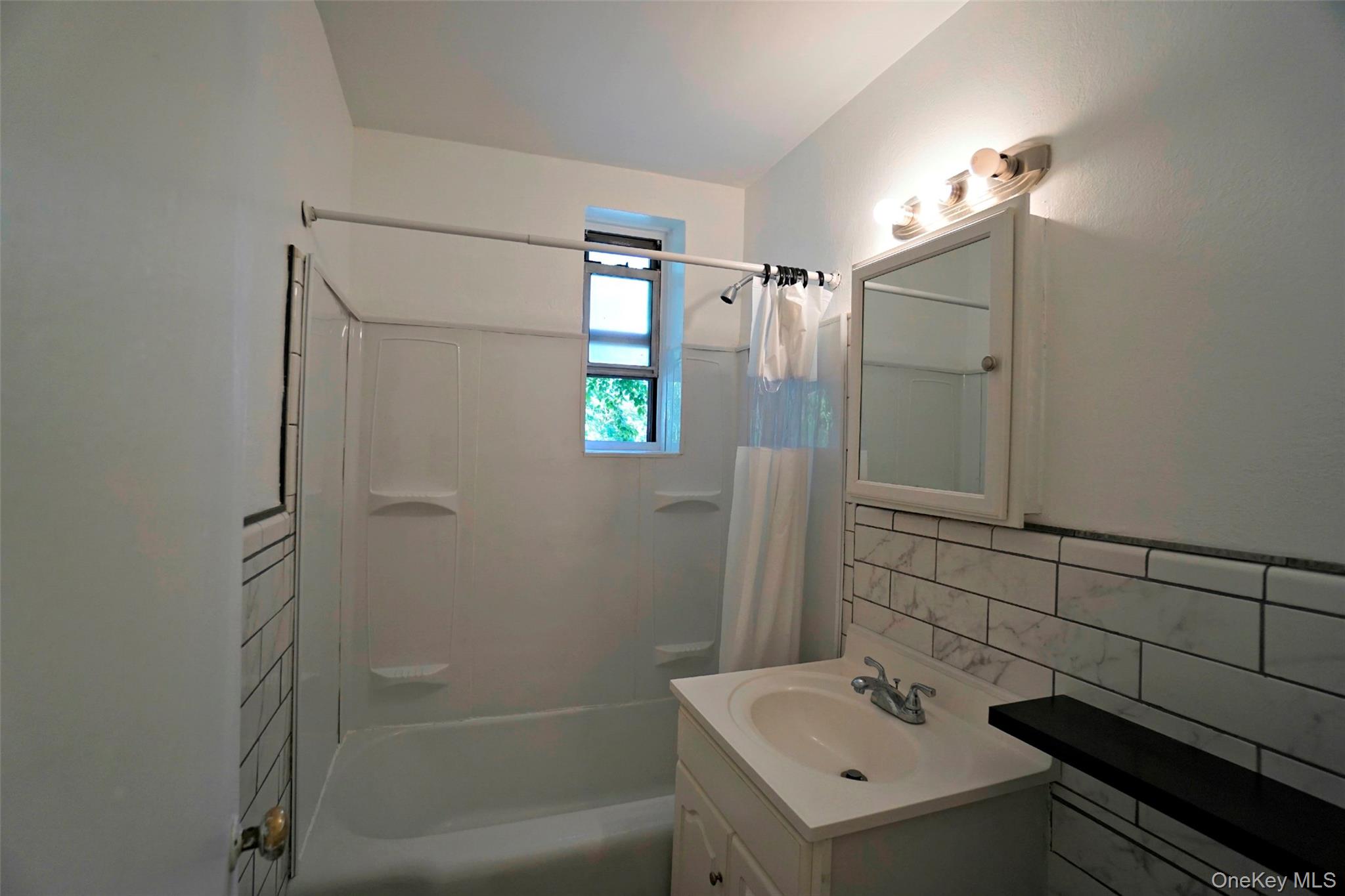 7281 113th Street, Unit 2B Queens, NY 11375 - Photo 6 of 18 a bathroom with a sink a toilet and shower
