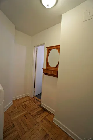 a view of a room with wooden floor