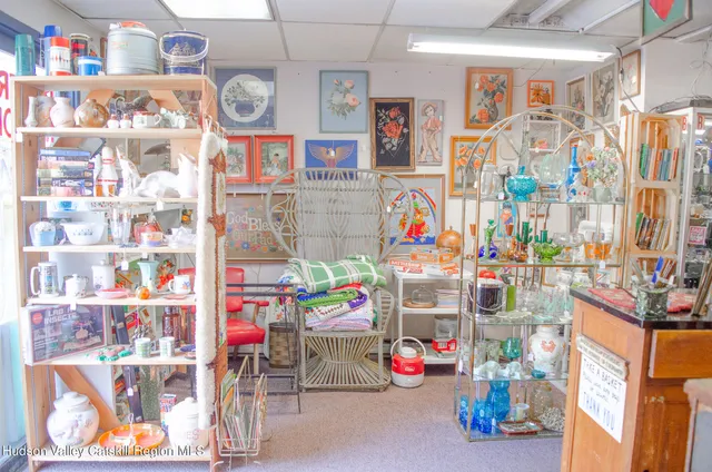 a utility room with stainless steel appliances a sink and a refrigerator
