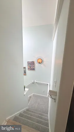 a kitchen with a sink white cabinets and white appliances