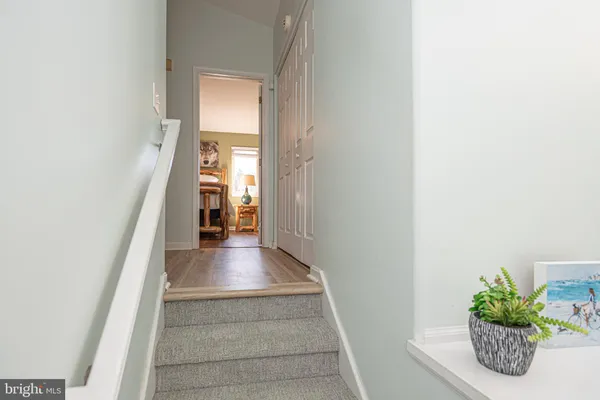 a kitchen with white cabinets sink and stove