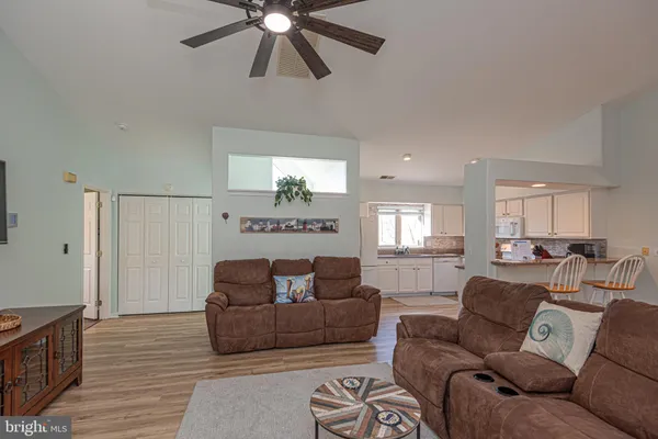 a bathroom with a sink a toilet and shower curtain