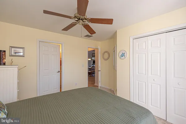 a bedroom with a bed and a mirror