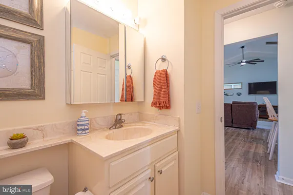 a living room with furniture kitchen view and a window