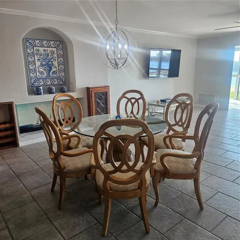a dining room with furniture and chandelier