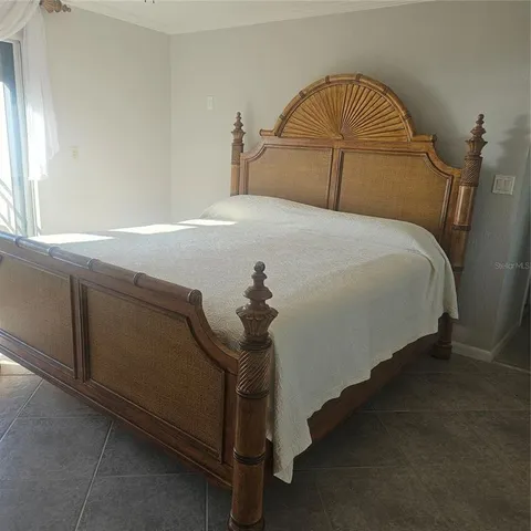 a bedroom with a bed and a chandelier