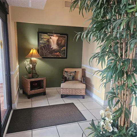 a living room with furniture and a potted plant