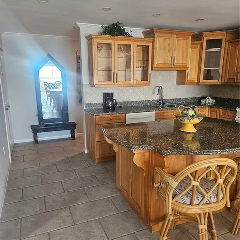 a kitchen with granite countertop a stove a sink and a granite counter tops