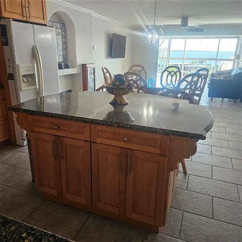 a kitchen with a refrigerator and a more cabinets