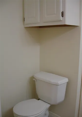 a bathroom with a granite countertop sink and toilet