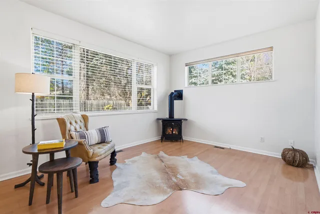 a view of a livingroom with workspace and a window