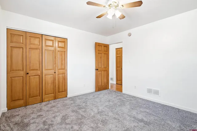 a view of a livingroom with a chandelier fan