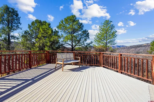 a view of balcony with wooden floor and seating space