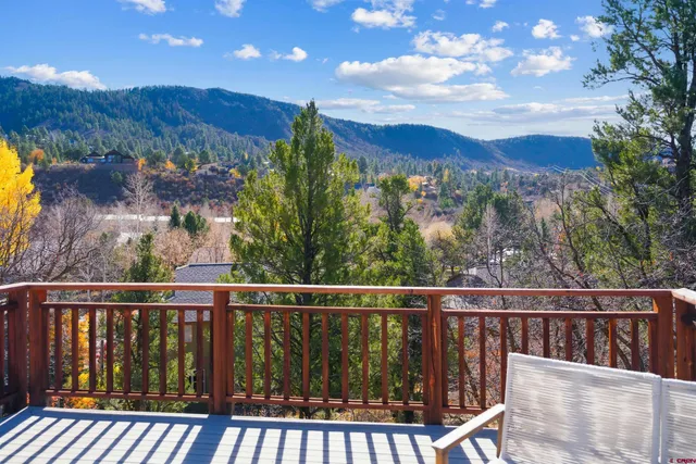 a view of a hallway with wooden floor and entryway