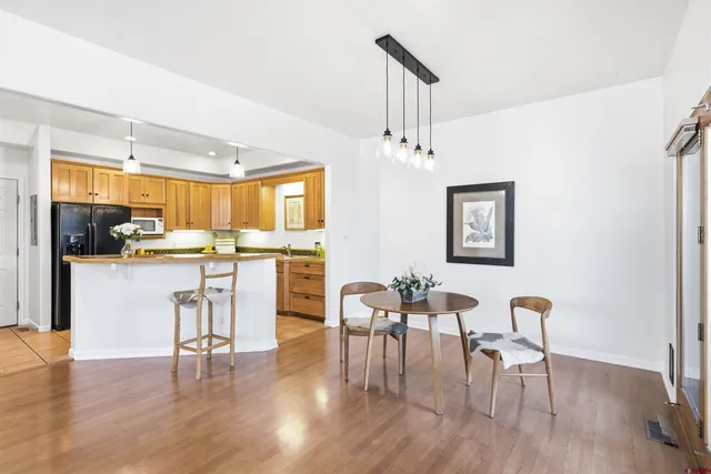 a dining room with furniture and wooden floor
