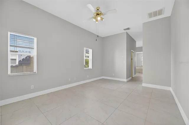 a view of a livingroom with a ceiling fan and window