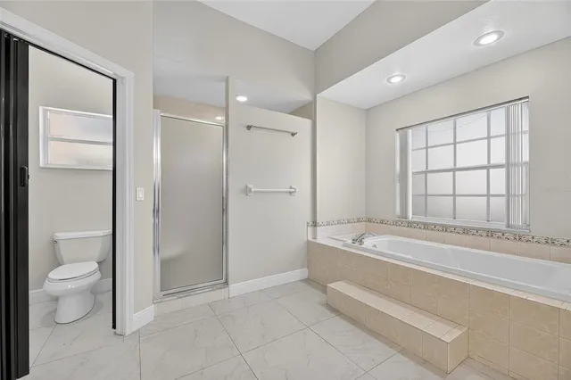 a view of empty room with a window and a ceiling fan