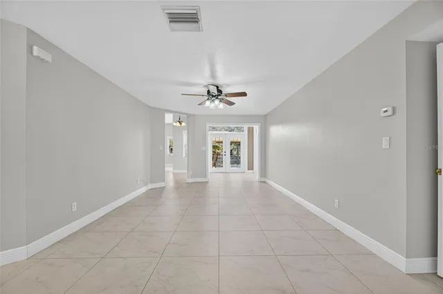 a kitchen with stainless steel appliances kitchen island granite countertop a refrigerator a stove top oven and a sink with granite countertops