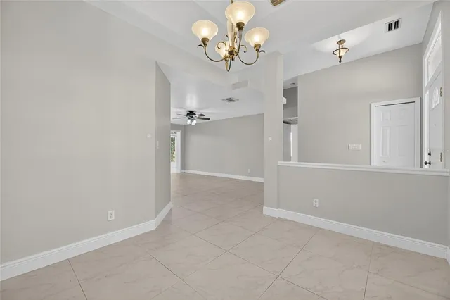 a kitchen with granite countertop a sink stainless steel appliances white cabinets and a window
