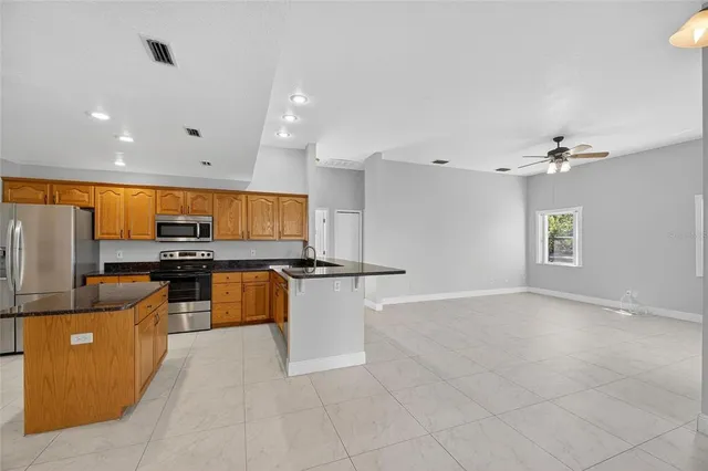 a bathroom with a granite countertop sink a toilet and mirror