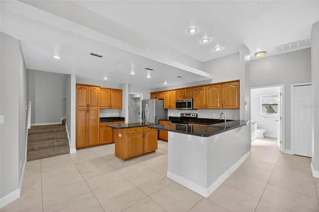 a view of a kitchen with cabinets and a refrigerator
