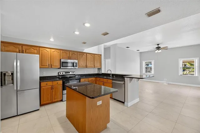 an empty room with a chandelier fan