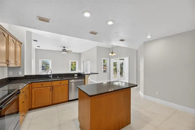 a view of a backyard with plants and patio