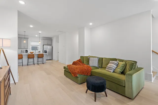 a living room with furniture and kitchen view