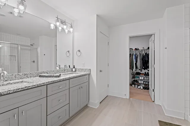 a bathroom with a double vanity sink and a mirror