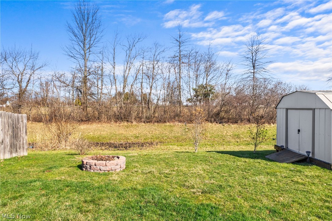 378 Springbrook Circle Elyria, OH 44035 - Photo 15 of 33 View of yard with a fire pit and a storage shed