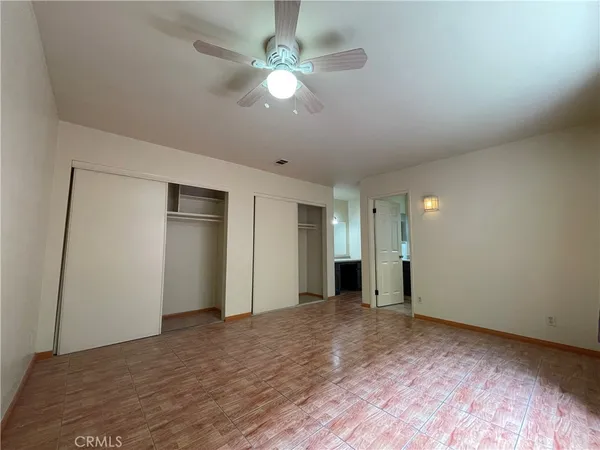 a view of an empty room with a ceiling fan
