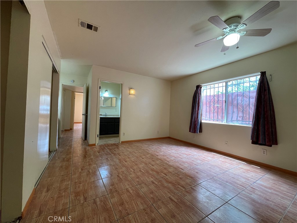 1349 Walnut Avenue Long Beach, CA 90813 - Photo 10 of 13 a view of a livingroom with a fireplace a ceiling fan and windows