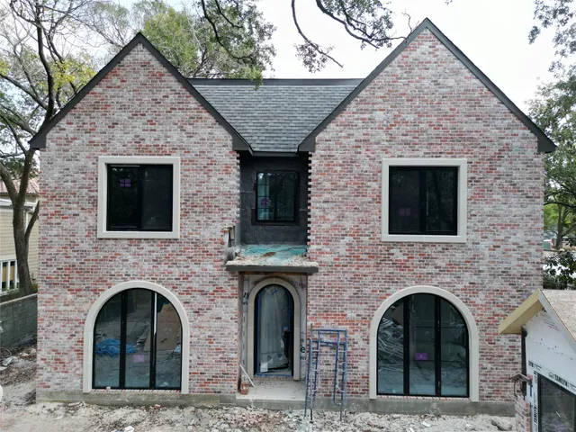 a front view of a house with brick wall