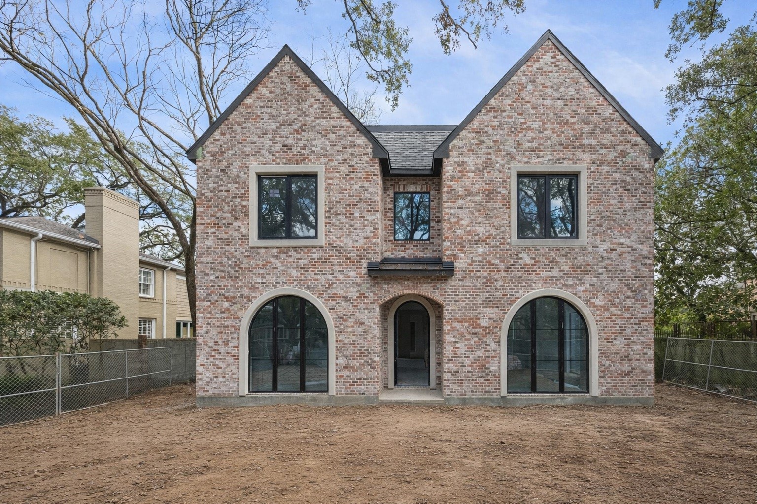 2247 Chilton Road Houston, TX 77019 - Photo 2 of 16 2/19/26 Exterior is finished in Old Texas Red Brick and highlighted with dark bronze stucco and accents.