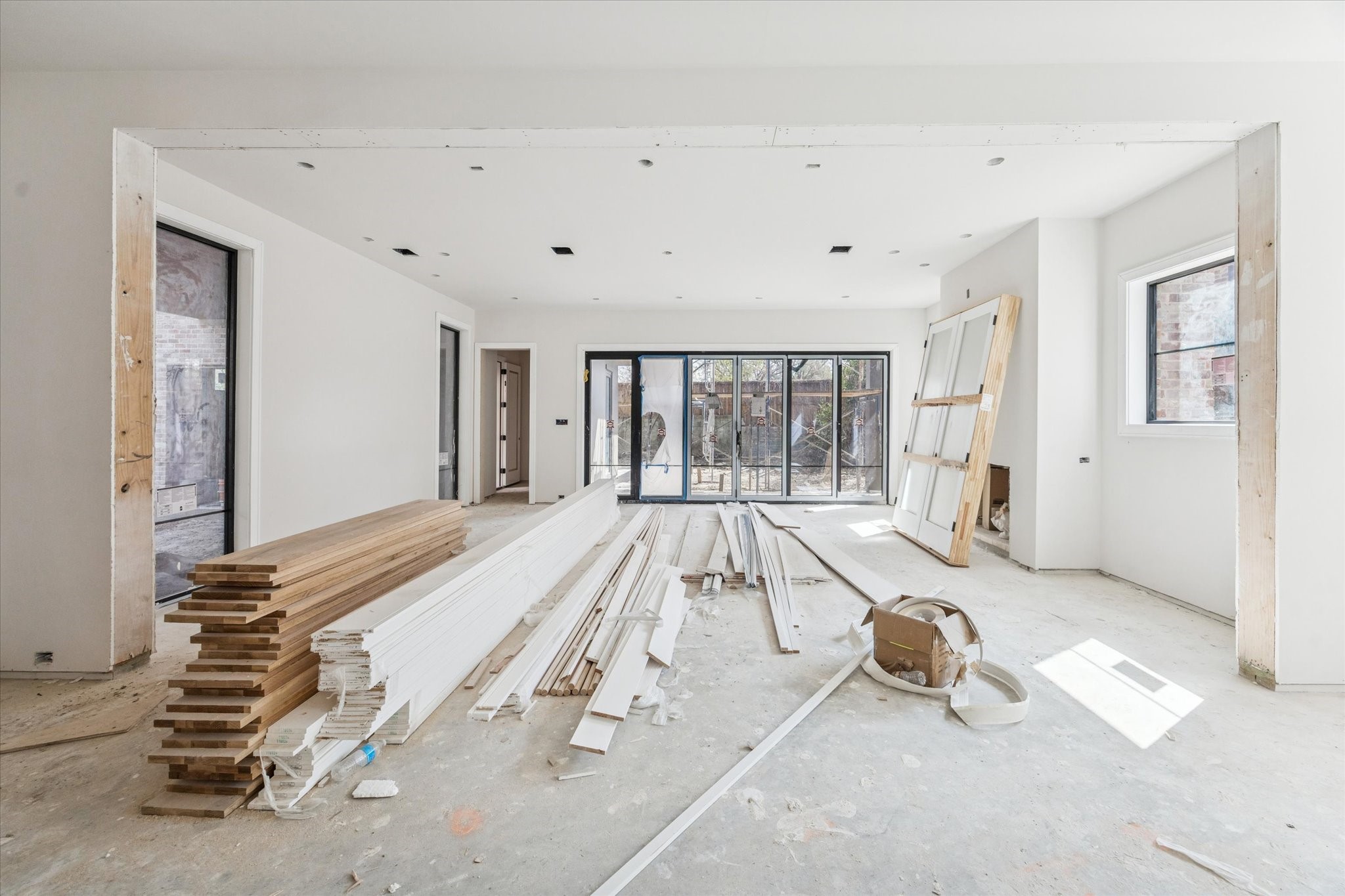 2247 Chilton Road Houston, TX 77019 - Photo 8 of 17 2/19/26 view of family room with glass accordion door to back yard with summer kitchen.