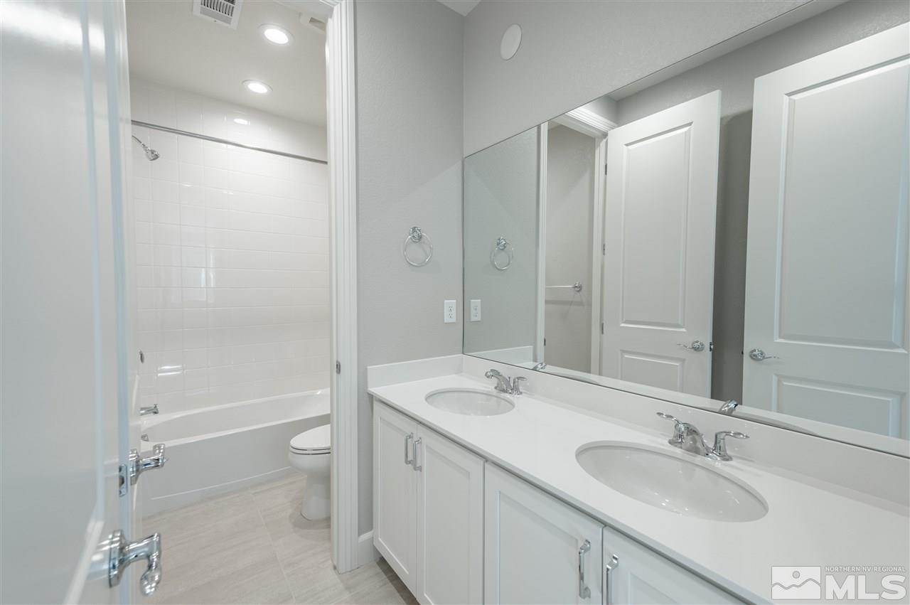 9326 Mayfair Way, Unit HOMESITE 66 Reno, NV 89521 - Photo 23 of 30 a bathroom with a sink double vanity granite tub and shower