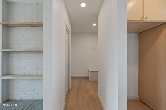 a big room with a fireplace and ceiling fan