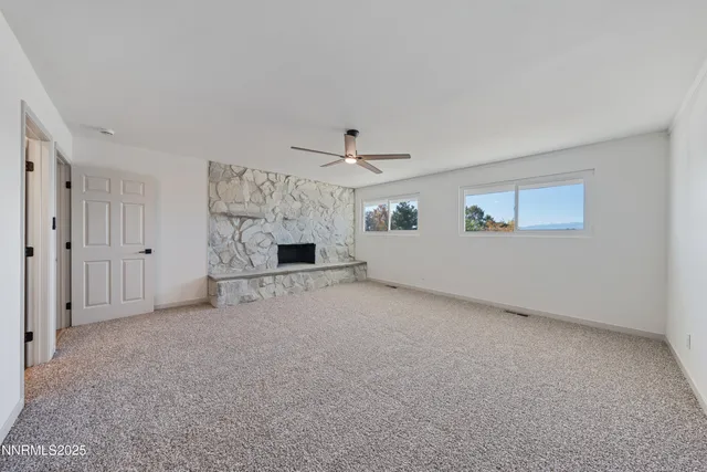 an empty room with closet and ceiling fan